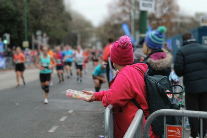 A group of people running down a street